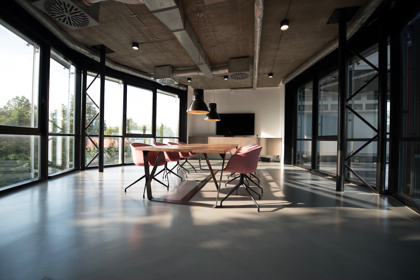 Sunlit office with shared workspaces and meeting areas